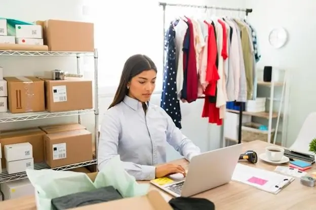 A woman focused on her laptop, diligently working in a well-organized office environment.