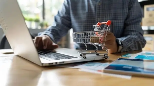 A laptop screen featuring a shopping cart, representing the concept of digital shopping and online retail.