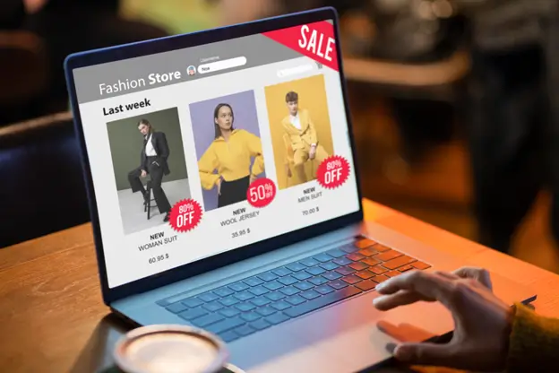 Online shopping for fashionable clothing and accessories on a laptop.