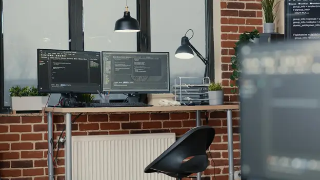 A modern desk featuring two computer monitors and a laptop, showcasing a productive workspace setup.